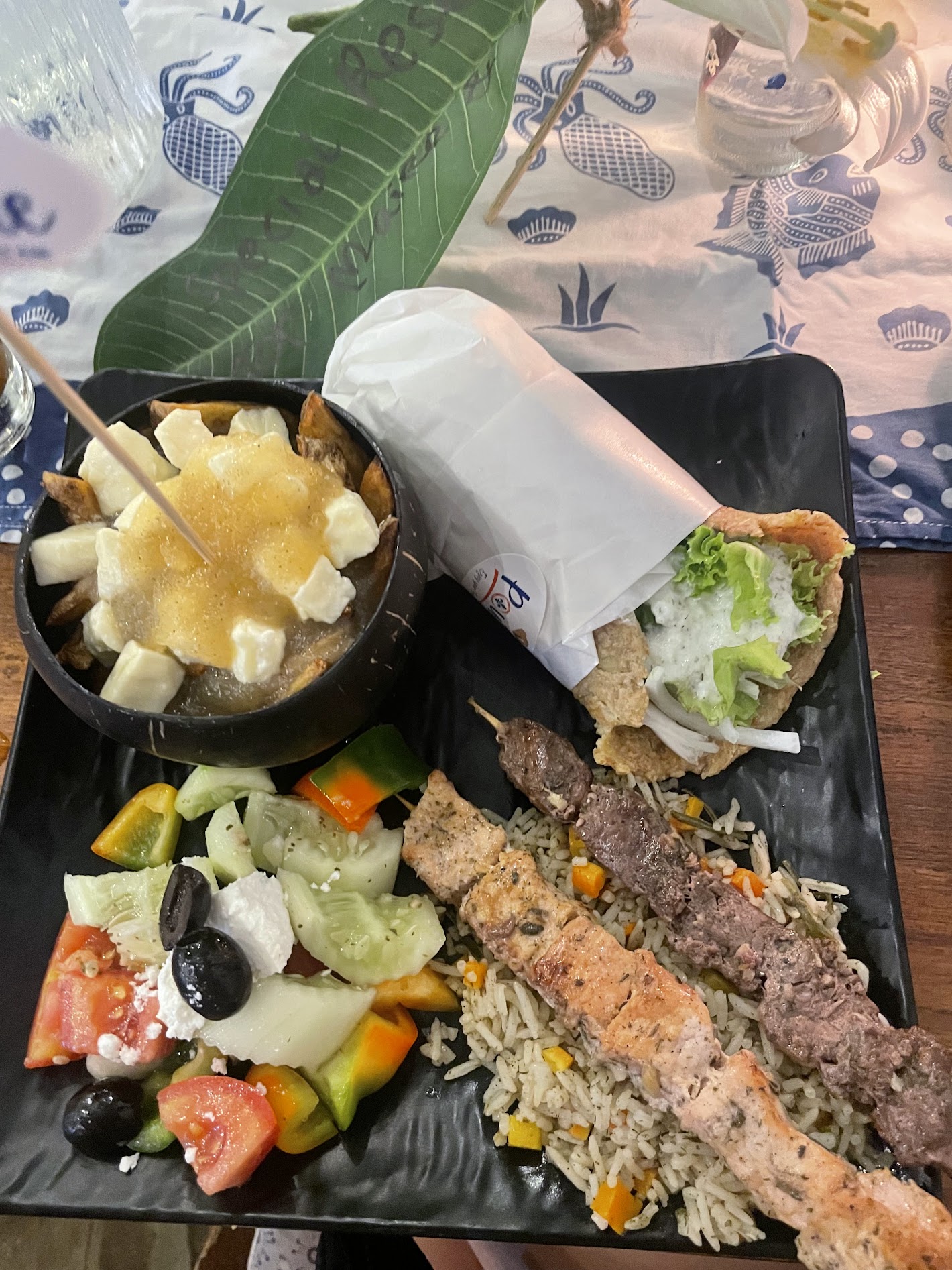 Greek platter with skewers and poutine